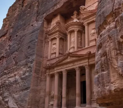 Image for main entrance to Petra with stone pillars carved into the mountain | Edgewood Travel